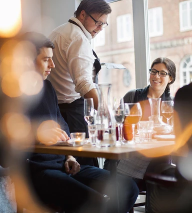 Waiter taking order on table